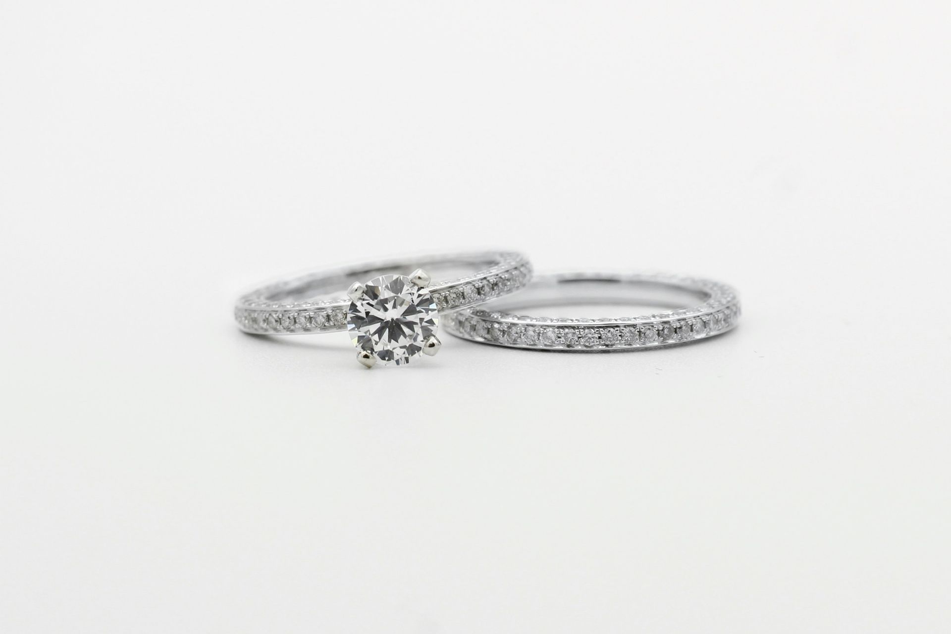 silver diamond studded ring on white surface